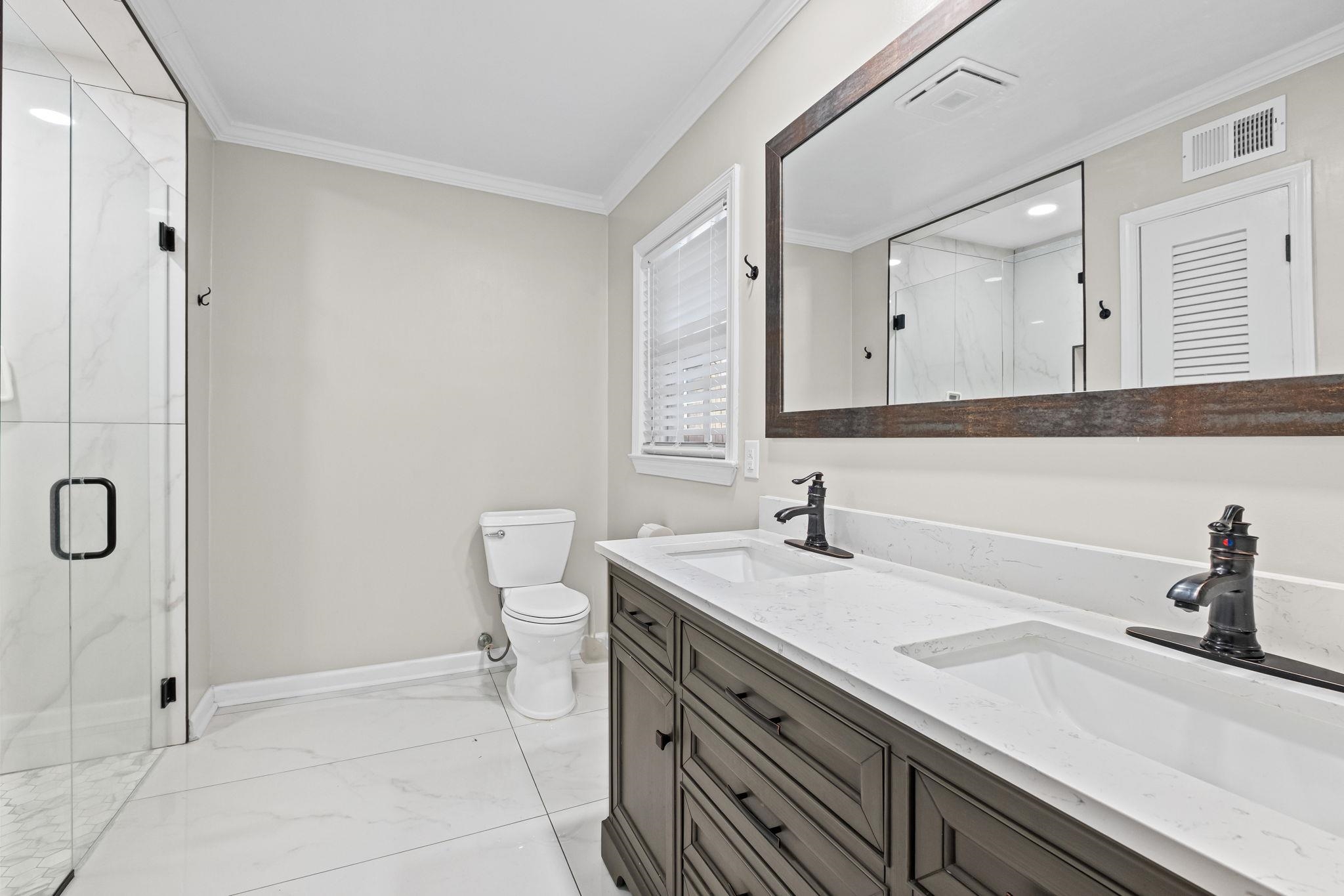 88 North Reese Street Memphis, TN 38111 - Photo 27 of 40 a bathroom with a sink a toilet and mirror