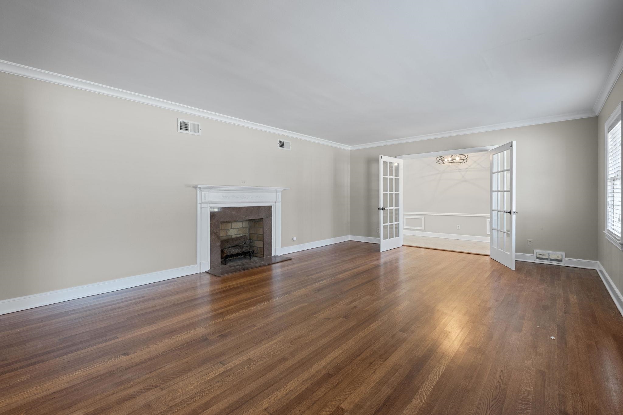 88 North Reese Street Memphis, TN 38111 - Photo 7 of 40 a view of an empty room with wooden floor fireplace and a window