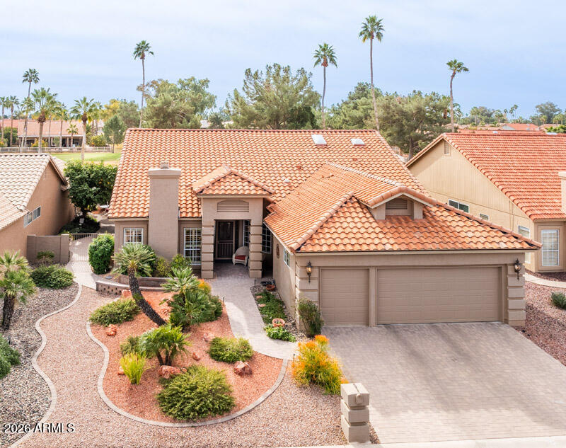 a view of a house with a yard and sitting area