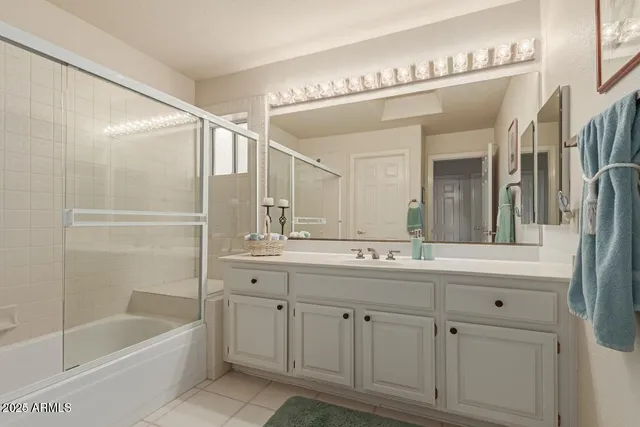 a bathroom with a tub a sink and mirror