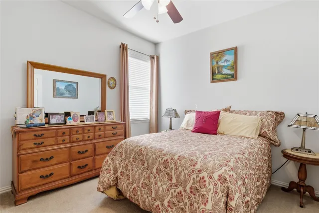 a bedroom with a bed and a dresser in it