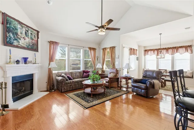 a living room with furniture large window and a fireplace