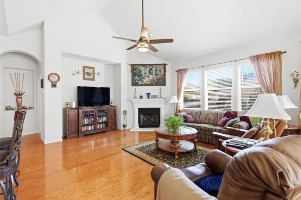 a living room with furniture a fireplace and a flat screen tv