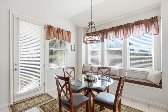 a view of a dining room with furniture windows and wooden floor