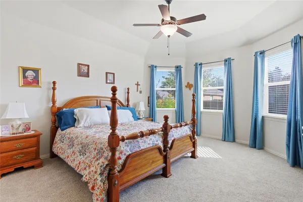 a bedroom with a bed and a chandelier