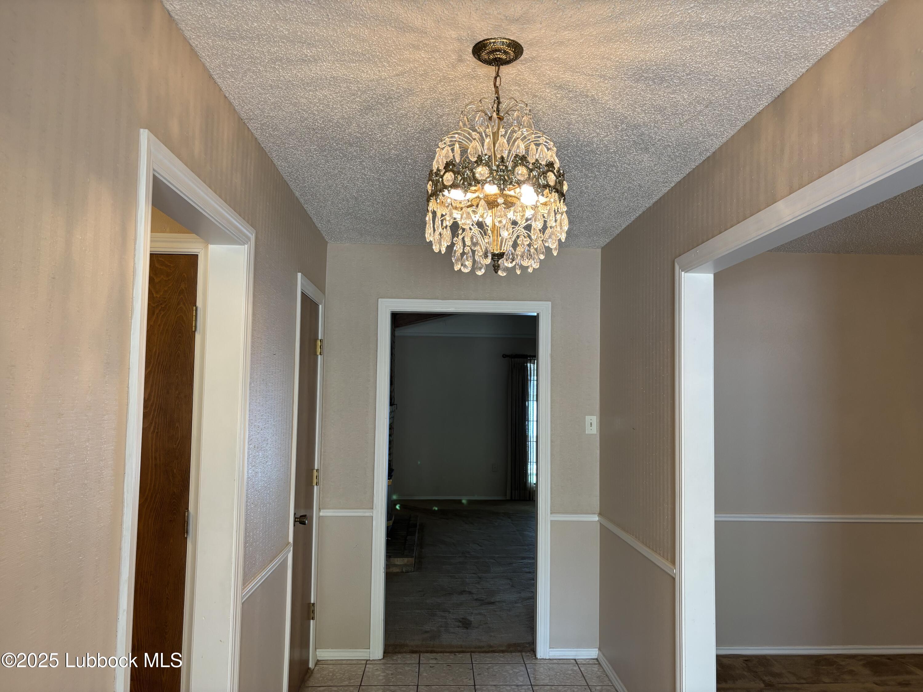 53 East Lakeshore Drive Ransom Canyon, TX 79366 - Photo 17 of 43 a view of a chandelier in a hallway