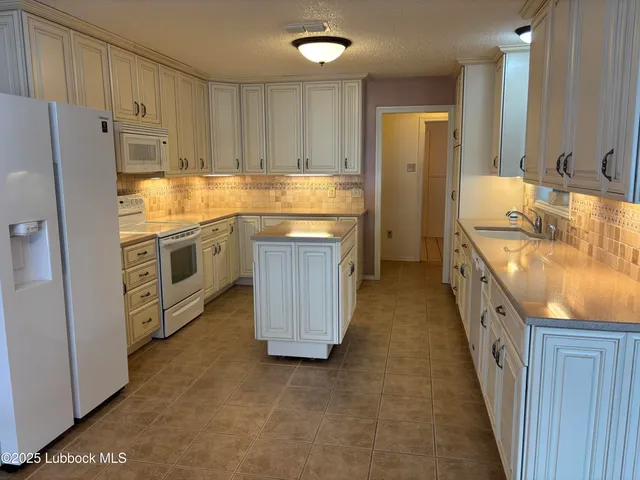 a kitchen with stainless steel appliances granite countertop a stove and a sink