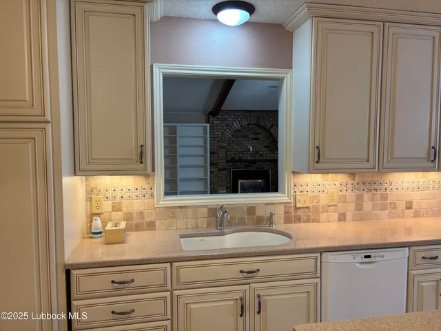 a kitchen with stainless steel appliances granite countertop a stove refrigerator sink and cabinets