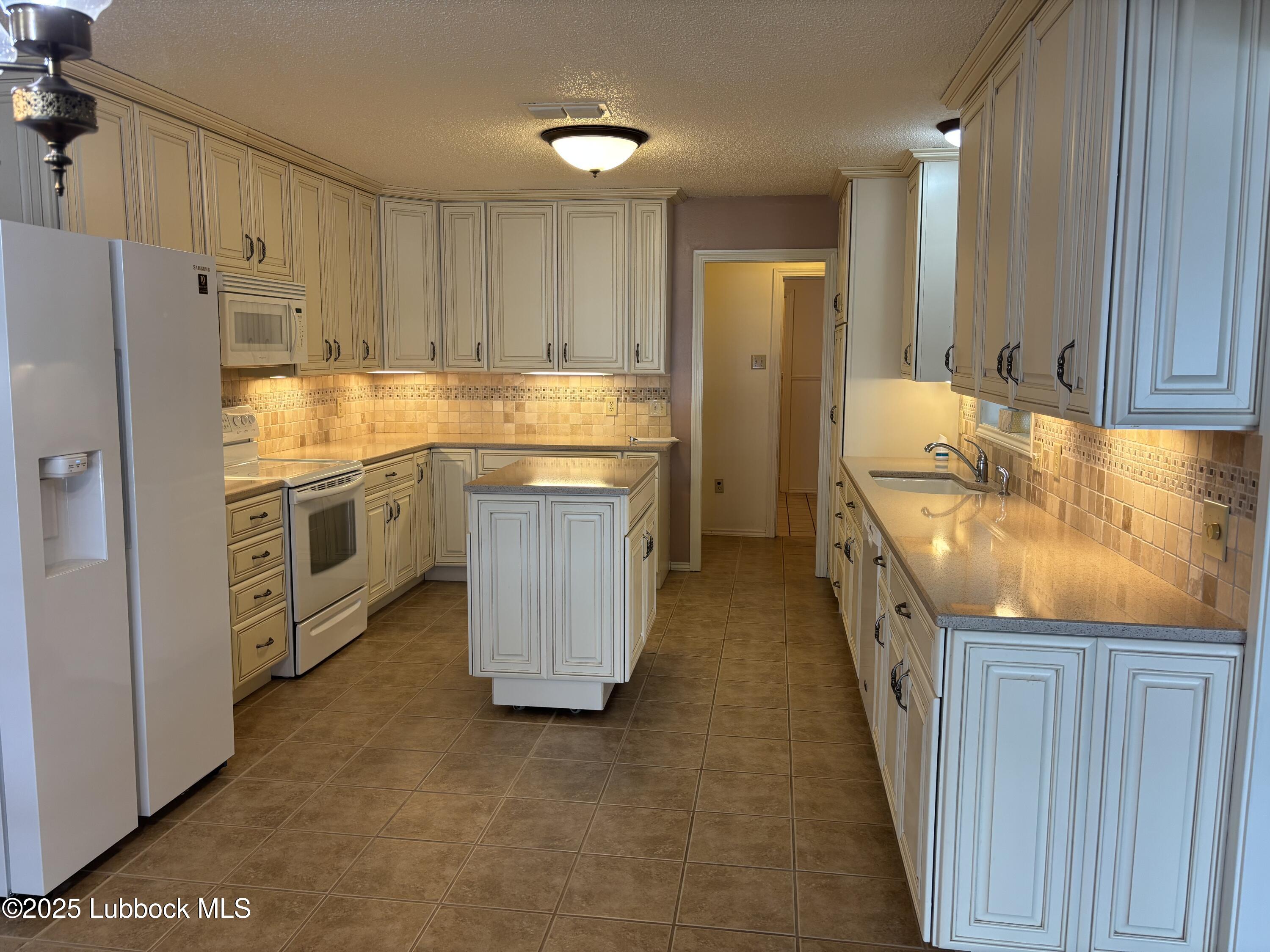 53 East Lakeshore Drive Ransom Canyon, TX 79366 - Photo 23 of 43 a kitchen with stainless steel appliances granite countertop a stove refrigerator sink and cabinets