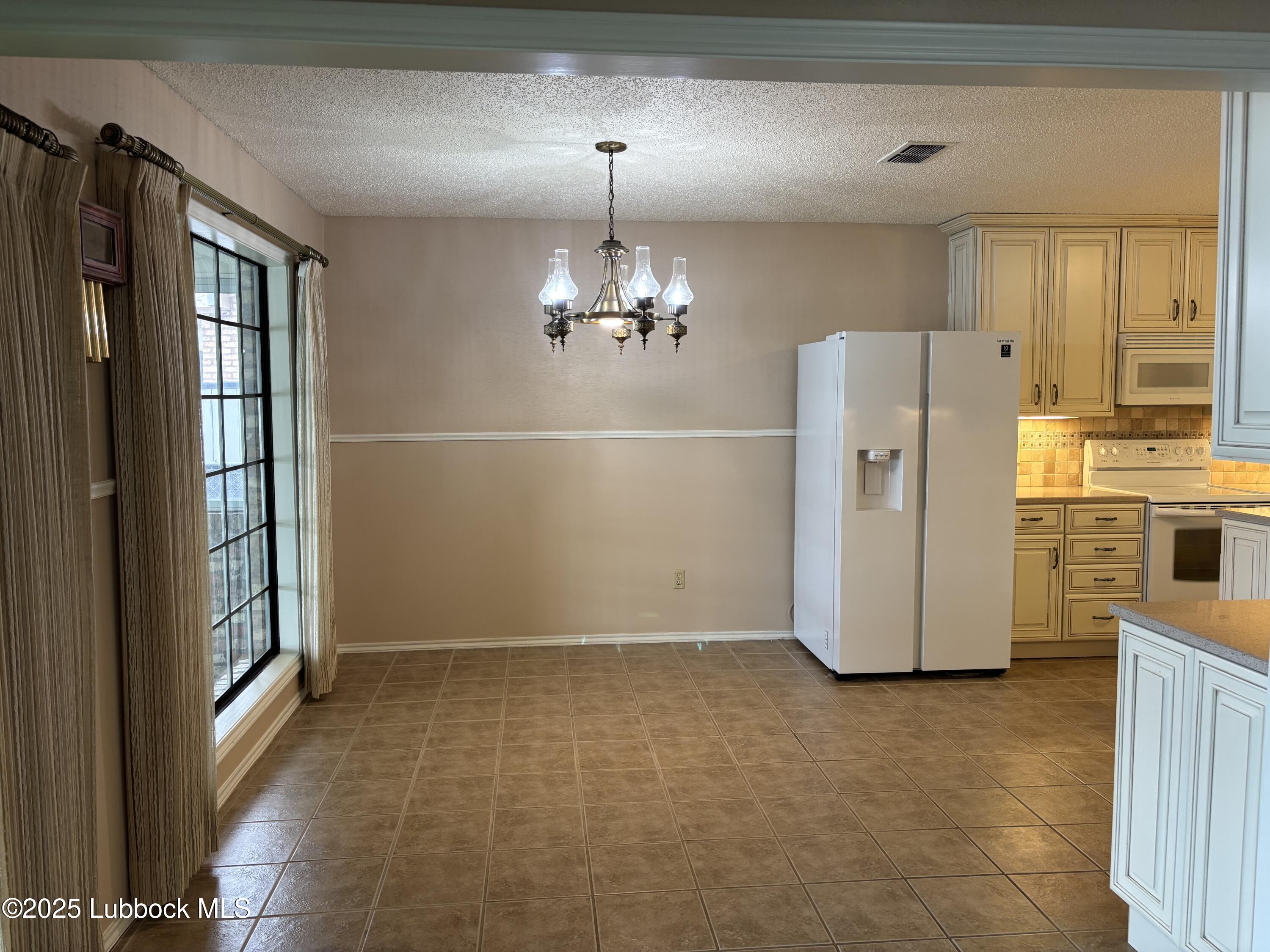 53 East Lakeshore Drive Ransom Canyon, TX 79366 - Photo 24 of 43 a view of a livingroom with a chandelier