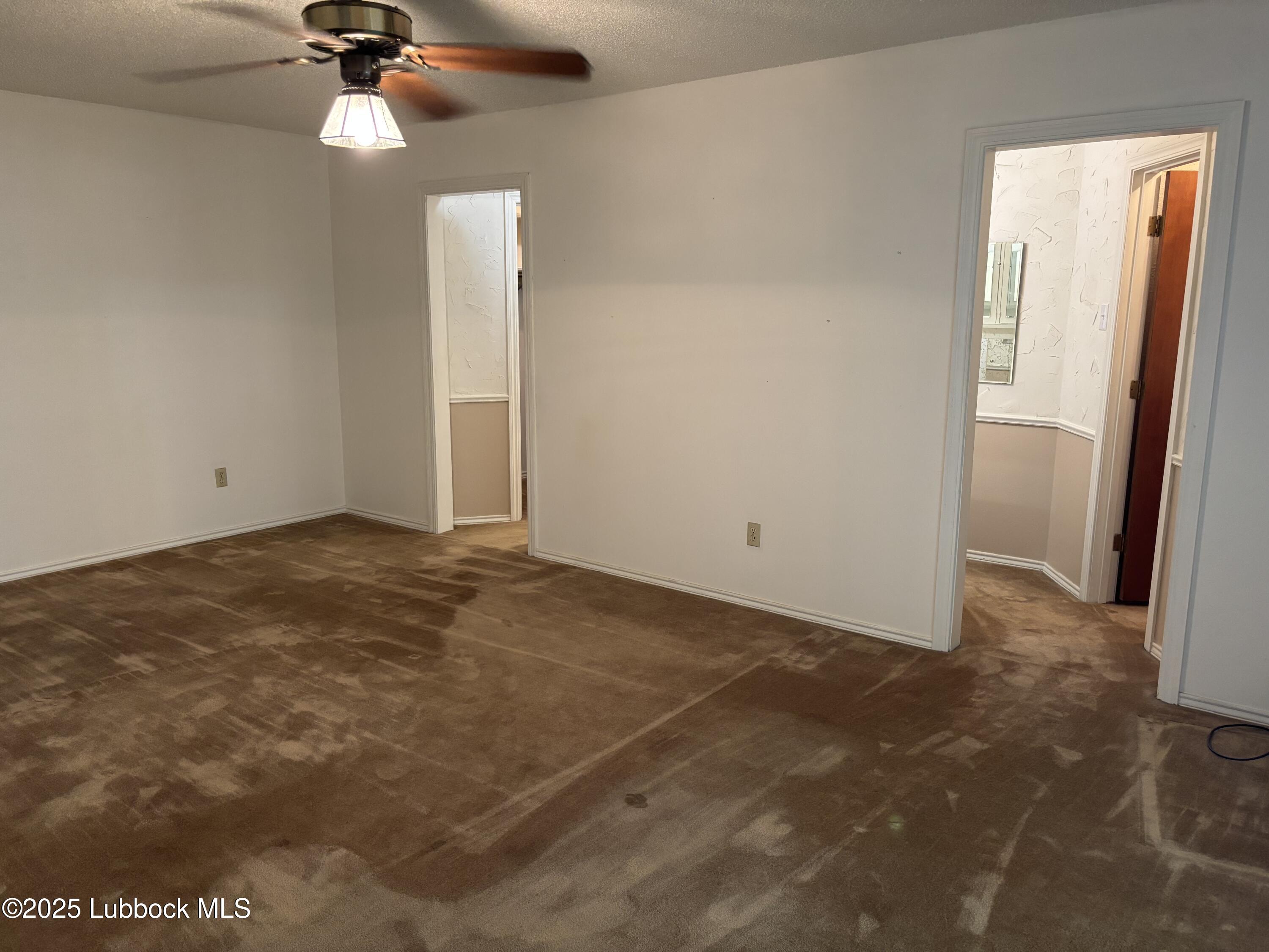 53 East Lakeshore Drive Ransom Canyon, TX 79366 - Photo 26 of 43 an empty room with closet and a chandelier fan