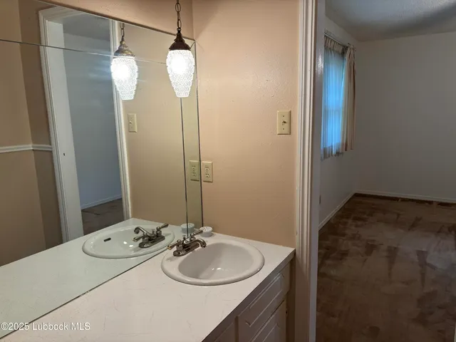 a bathroom with a granite countertop sink