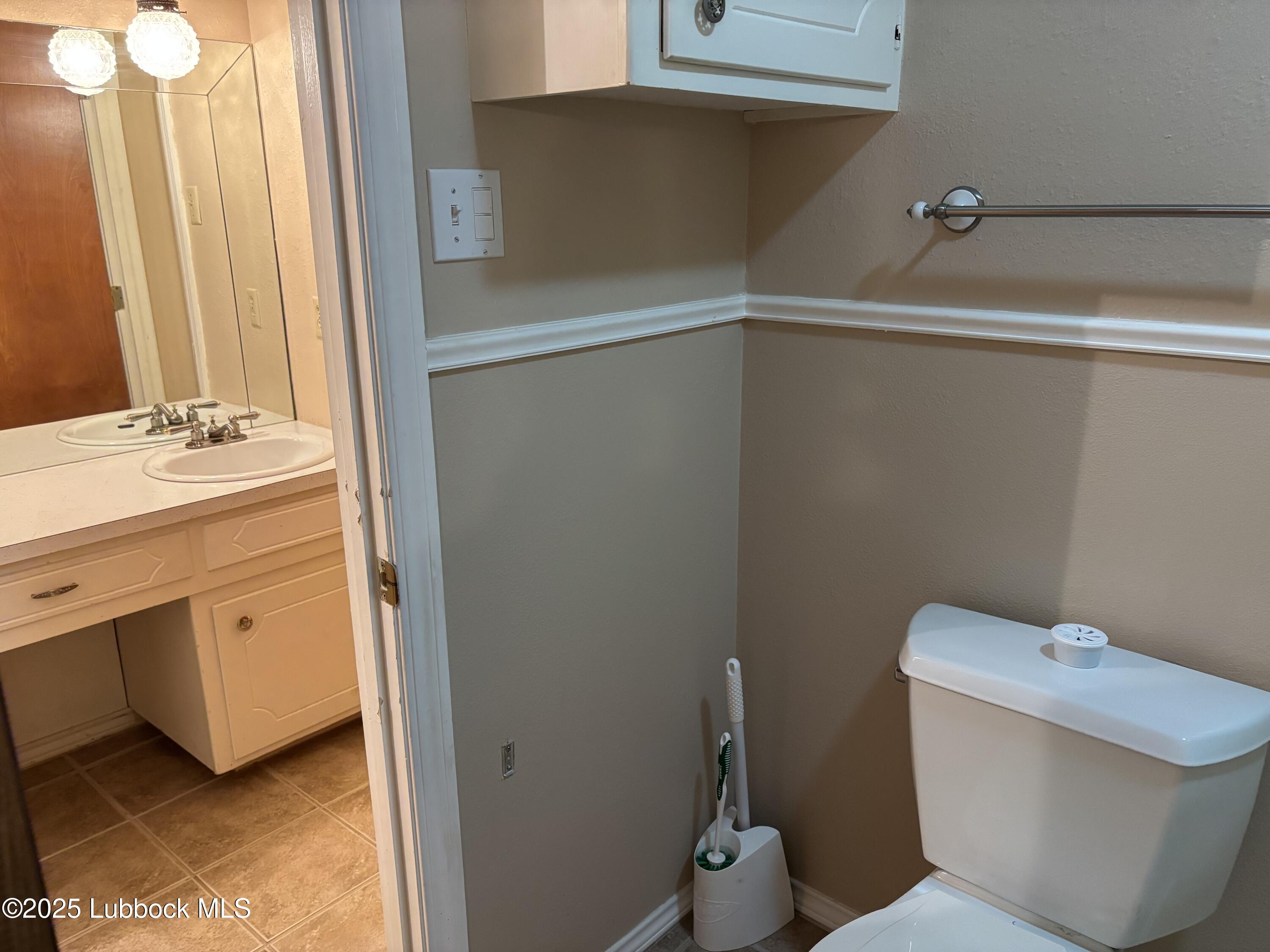 53 East Lakeshore Drive Ransom Canyon, TX 79366 - Photo 37 of 43 a bathroom with a toilet and a sink