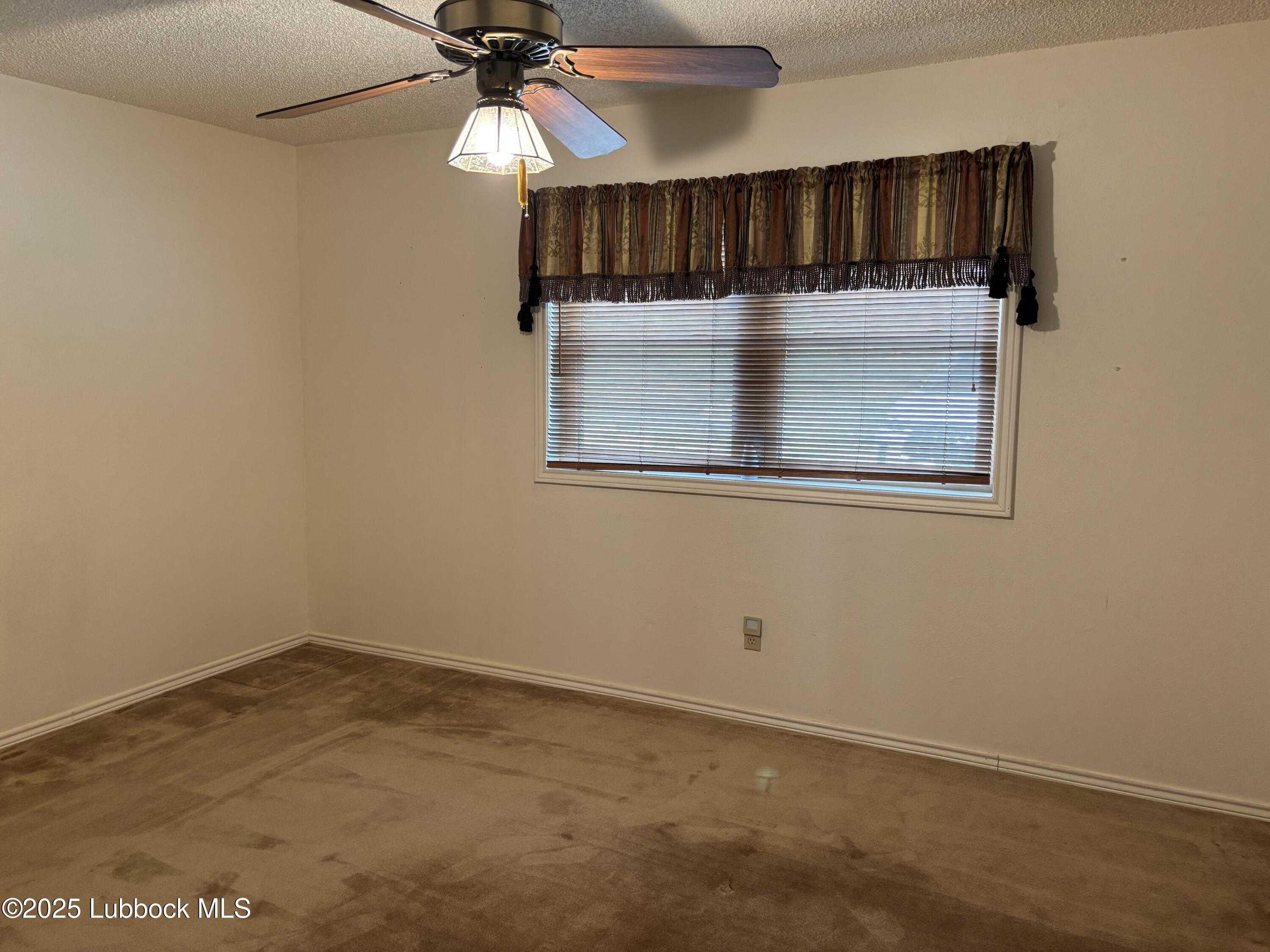 53 East Lakeshore Drive Ransom Canyon, TX 79366 - Photo 40 of 43 an empty room with fan