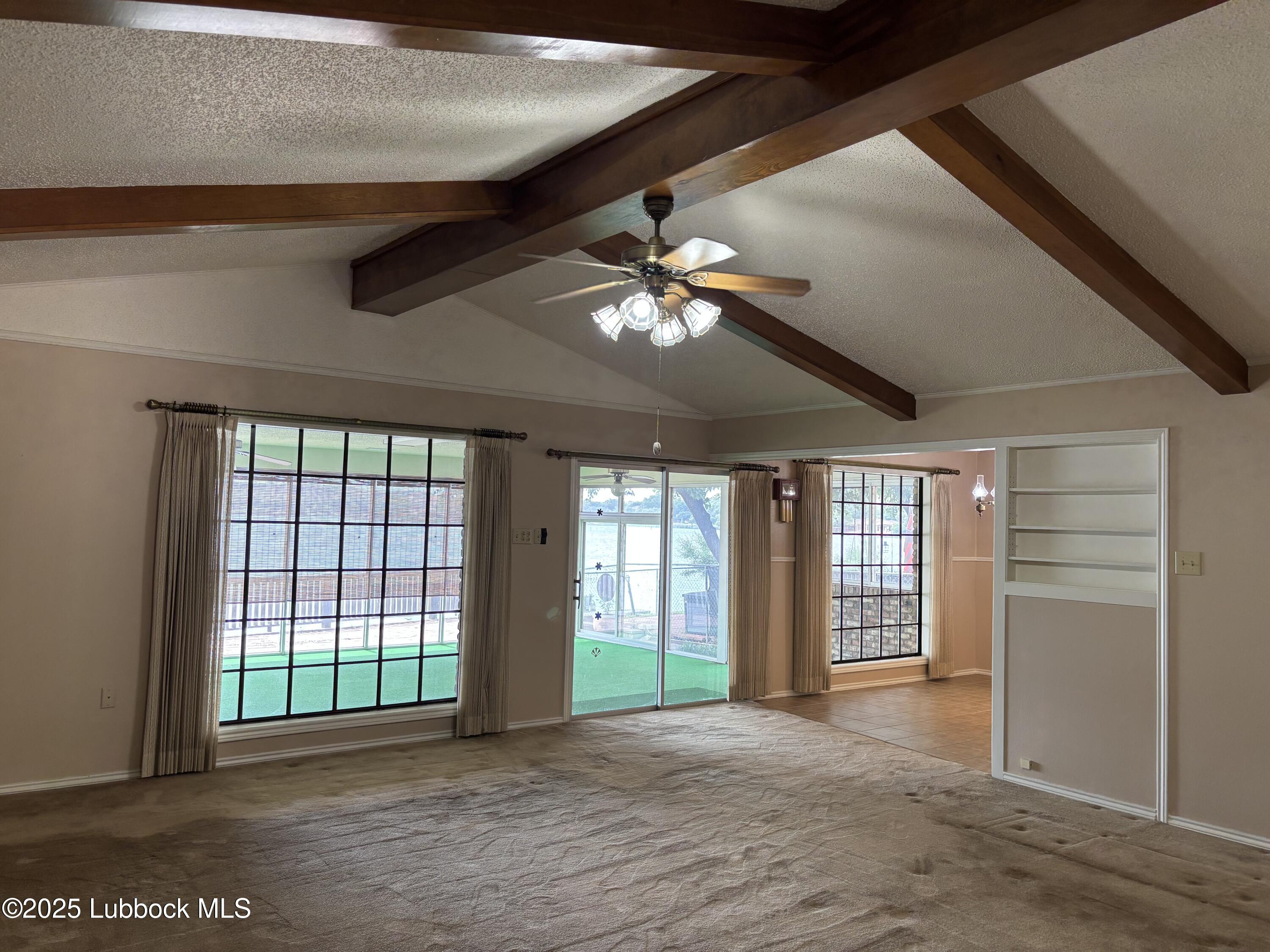 53 East Lakeshore Drive Ransom Canyon, TX 79366 - Photo 10 of 43 a view of a livingroom with a ceiling fan and window