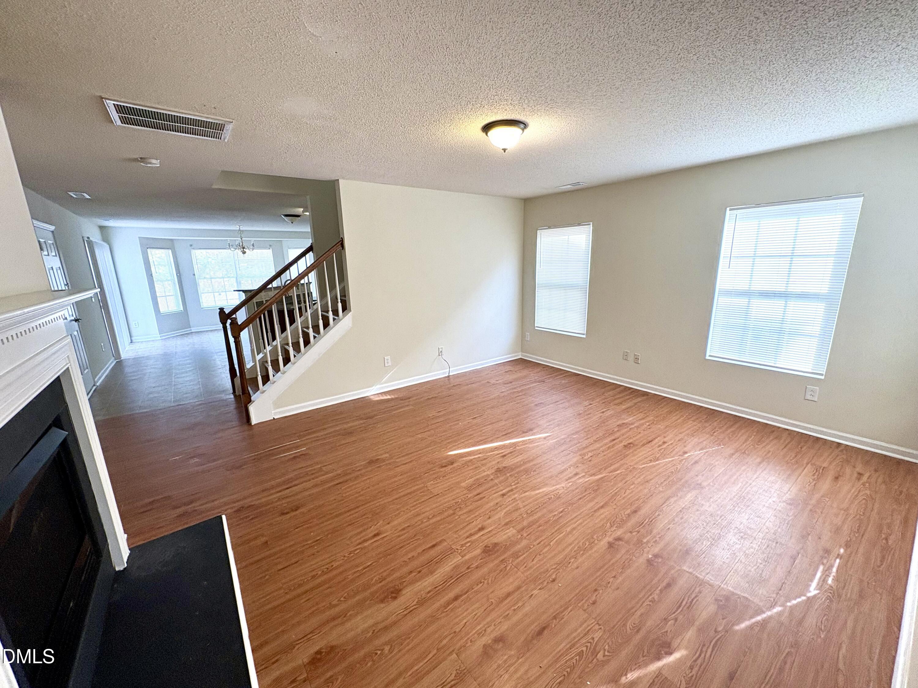 2422 Quarry Ridge Lane Raleigh, NC 27610 - Photo 2 of 10 a view of an empty room with wooden floor and a window