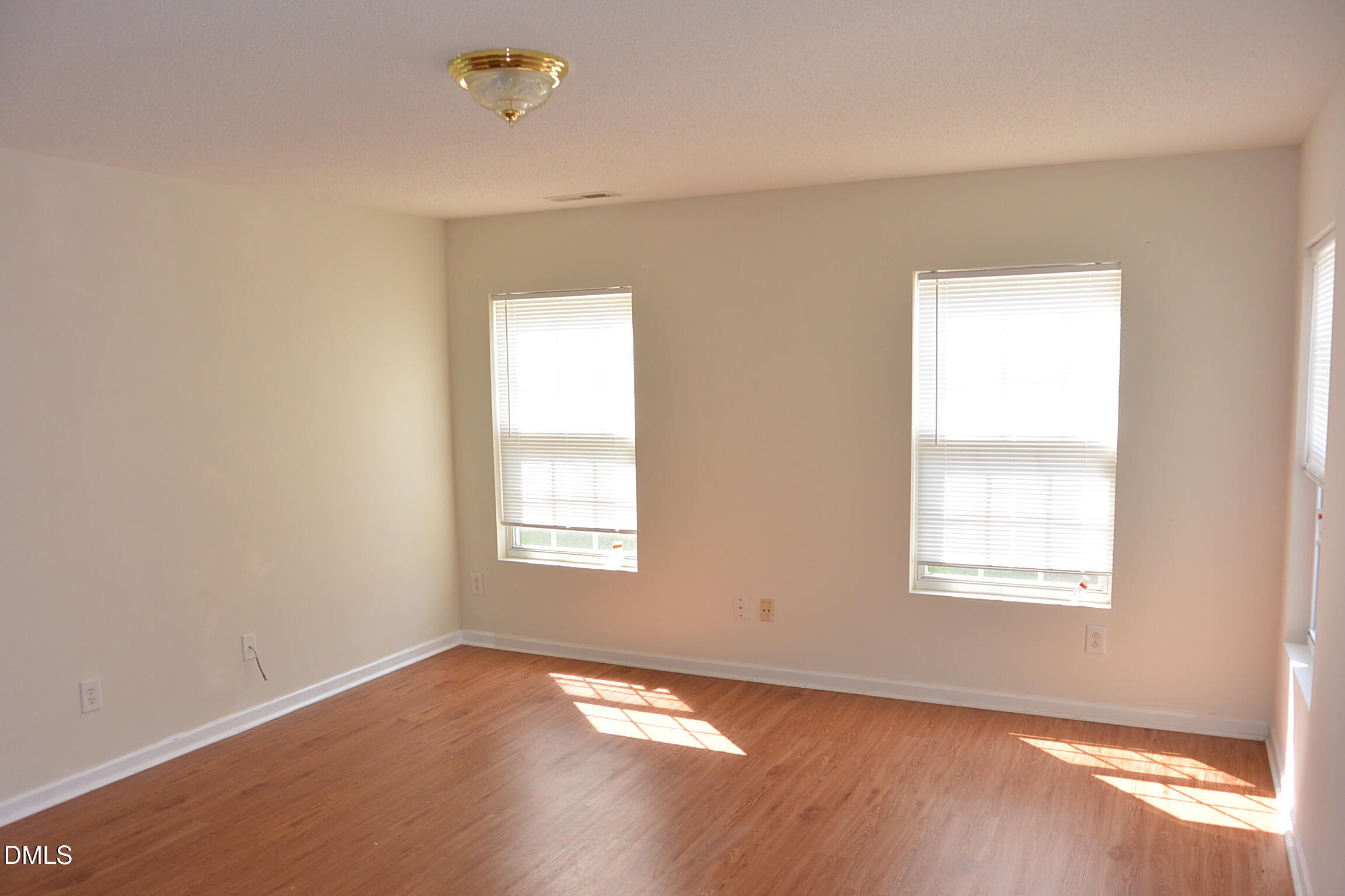 2422 Quarry Ridge Lane Raleigh, NC 27610 - Photo 5 of 10 an empty room with wooden floor and windows