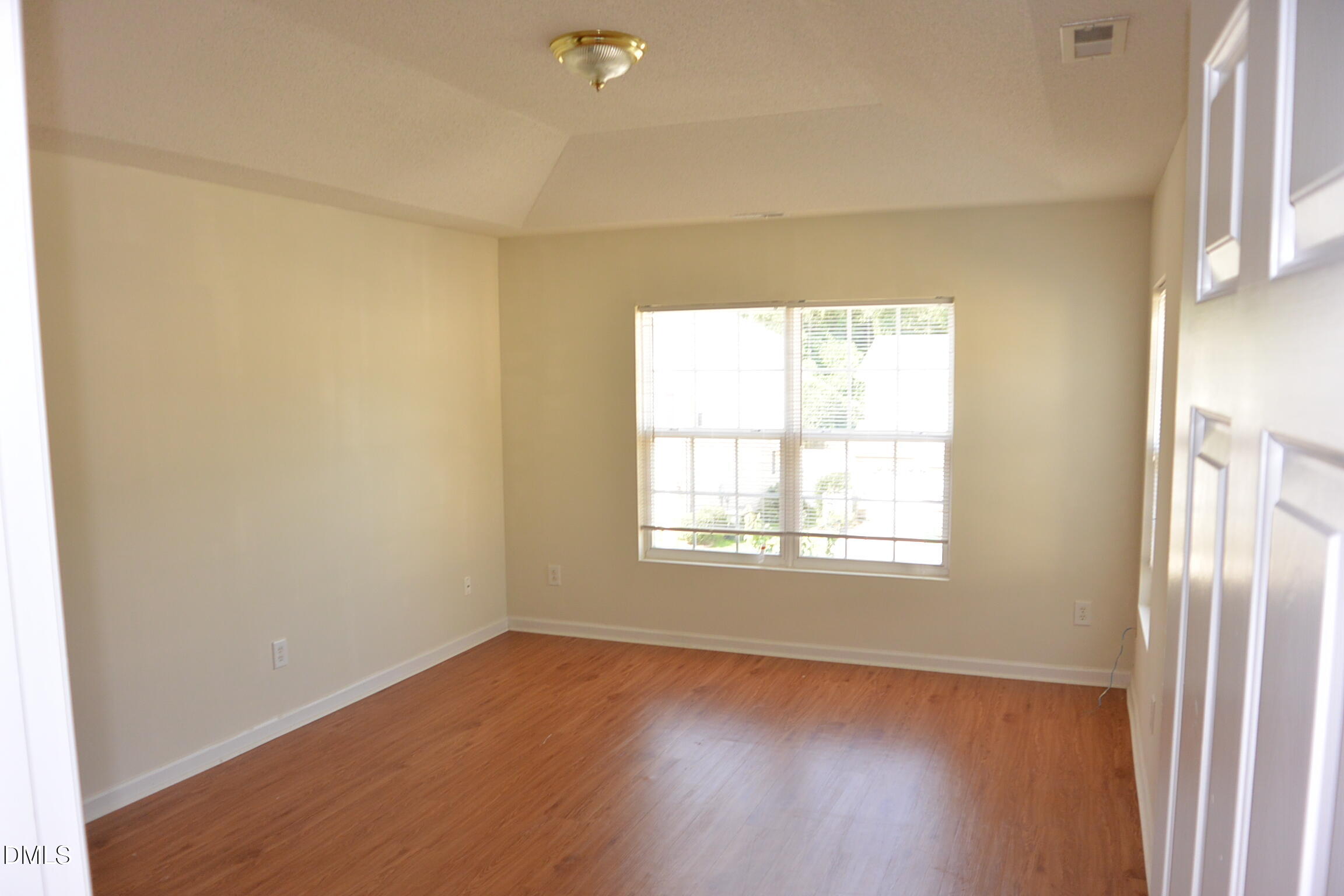 2422 Quarry Ridge Lane Raleigh, NC 27610 - Photo 6 of 10 an empty room with wooden floor and windows