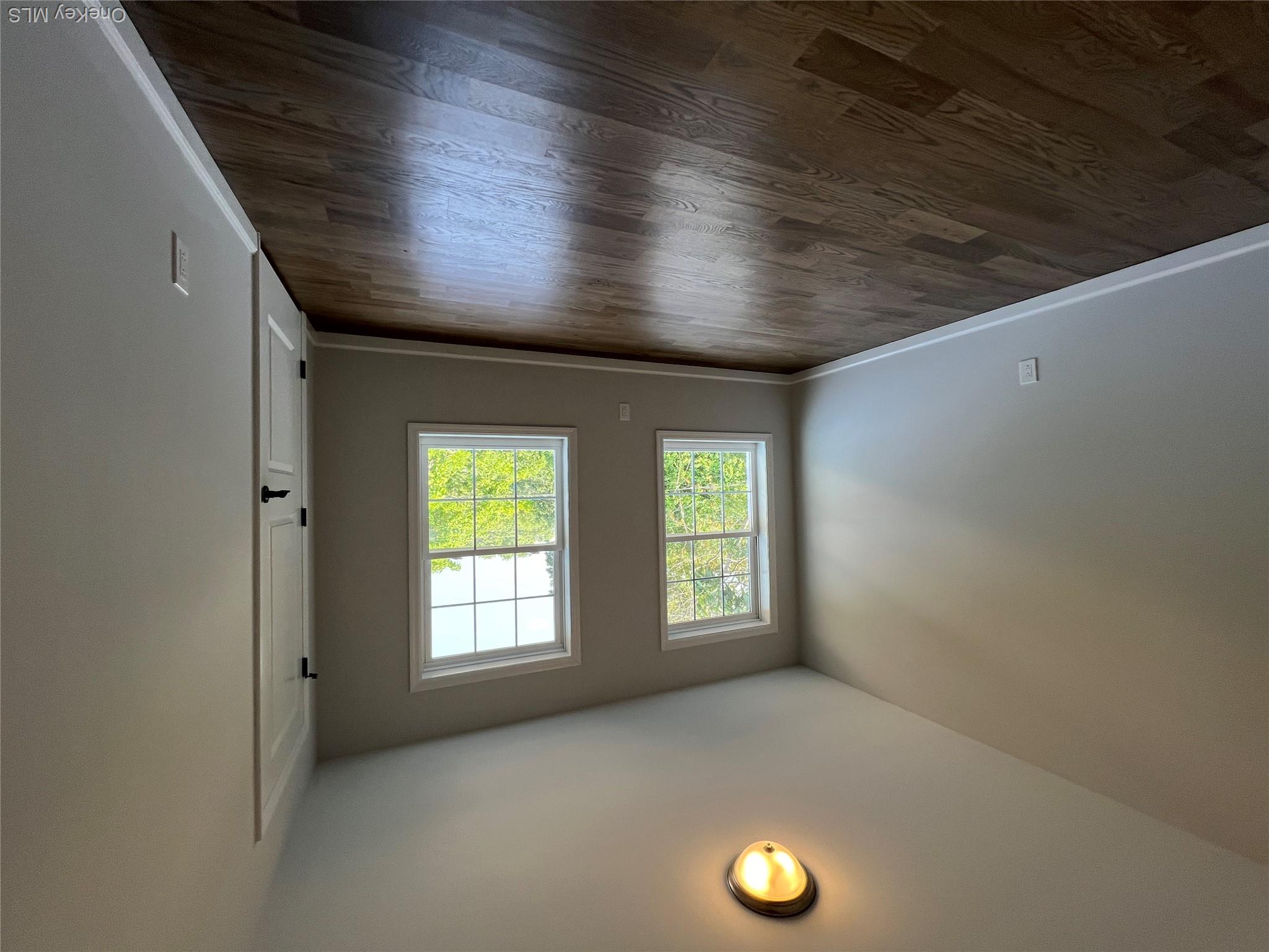 35 Babylon Road Mastic Beach, NY 11951 - Photo 15 of 19 an empty room with wooden floor and windows