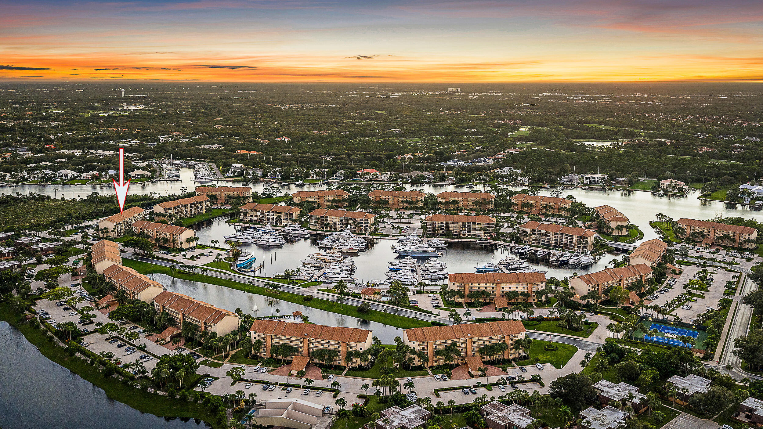1601 Marina Isle Way, Unit 402 Jupiter, FL 33477 - Photo 23 of 37 Sunset Aerial - Arrow to BLDG