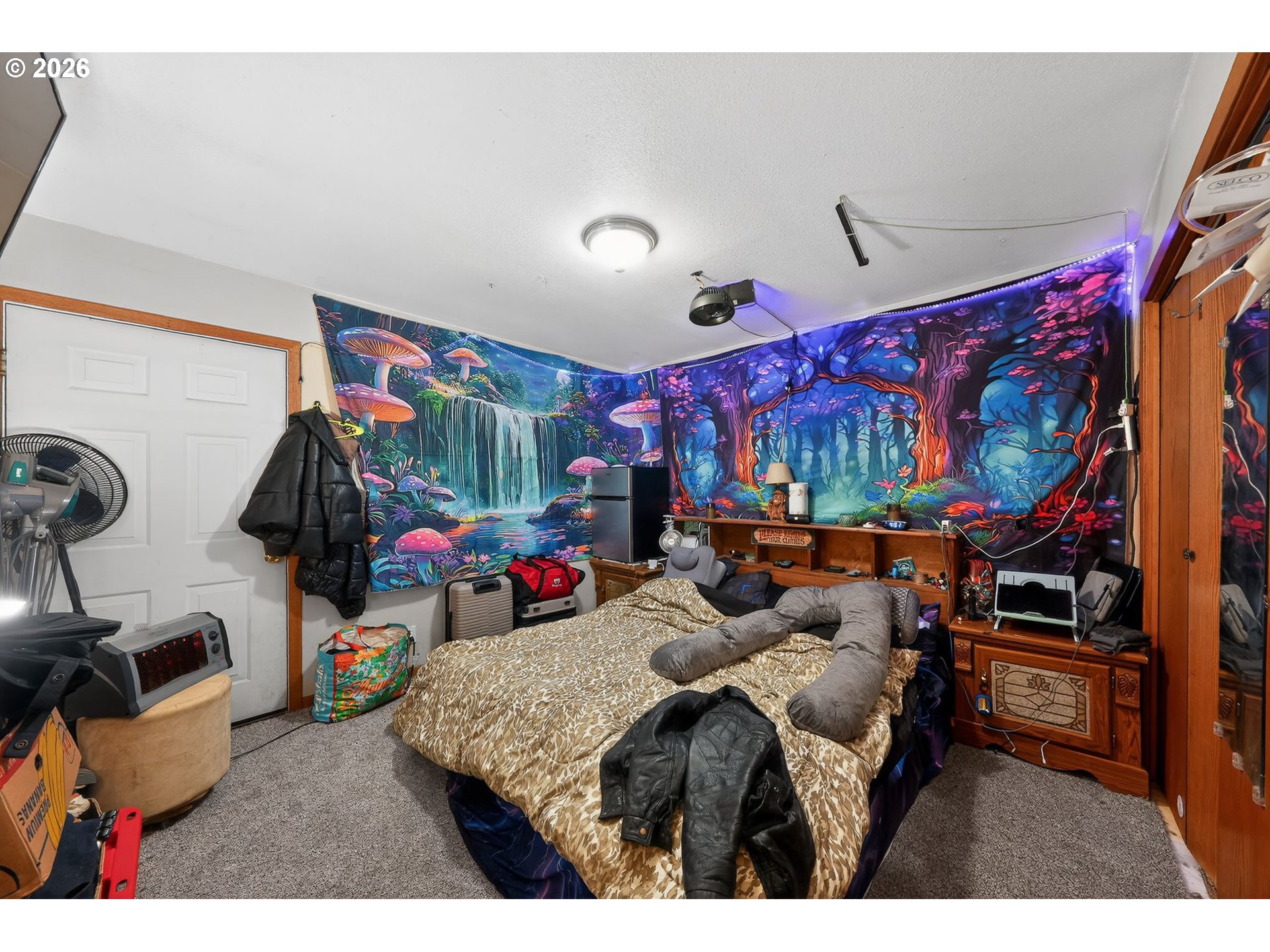 92981 Prairie Road Junction City, OR 97448 - Photo 12 of 29 a bedroom with furniture and a flat screen tv