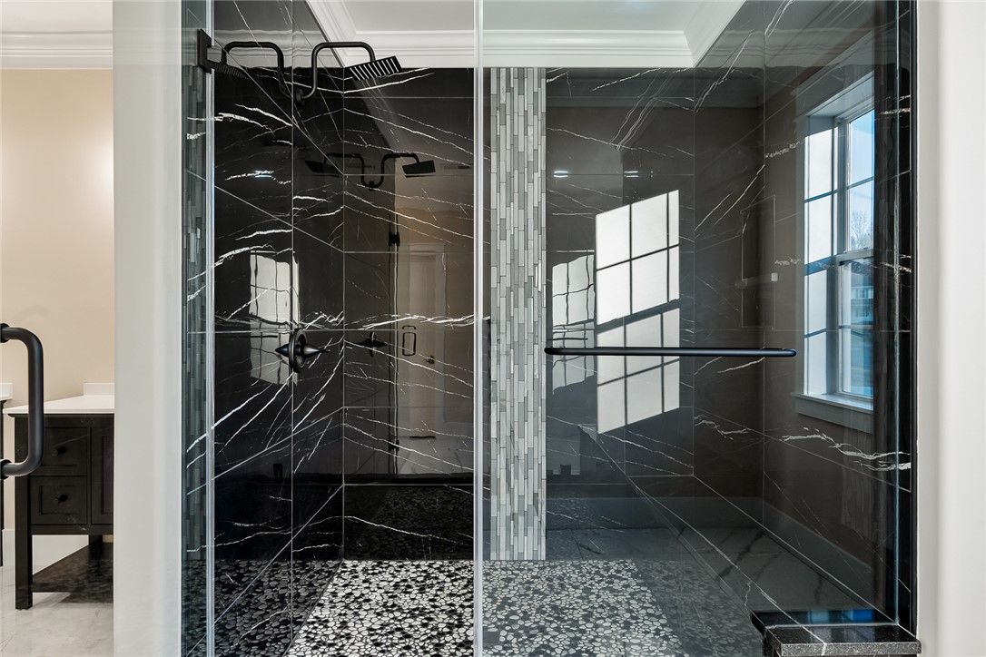 303 Regency Circle Anderson, SC 29625 - Photo 23 of 50 This sleek shower features luxurious dark marble and a rain showerhead, offering a refined bathing experience.