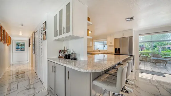 a kitchen with granite countertop a sink appliances and cabinets