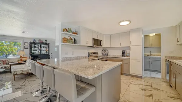 a kitchen with stainless steel appliances granite countertop a stove and cabinets