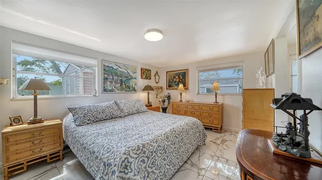 a bedroom with a bed and a lamp on dresser