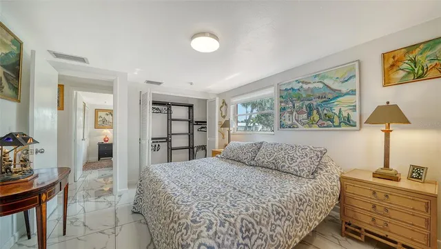 a bathroom with a toilet a sink a mirror a vanity and shower