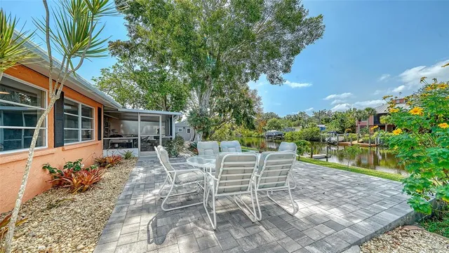 a view of a house with backyard sitting area and garden