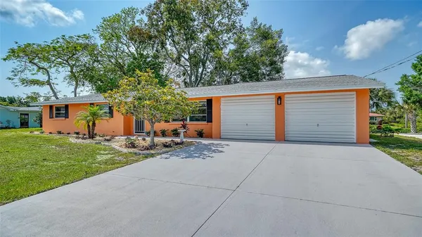 a view of a house with a yard and garage
