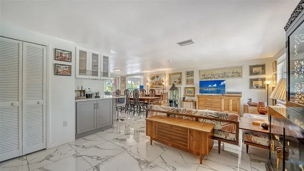 a living room with furniture and a kitchen