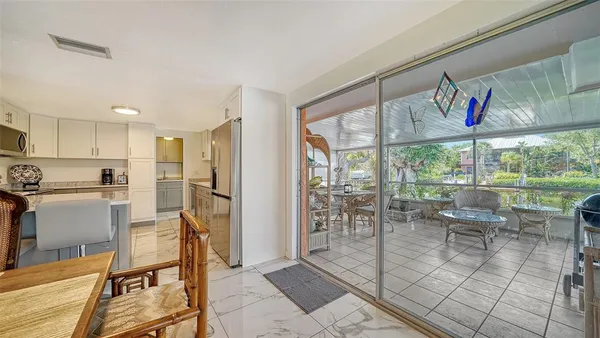 a view of a kitchen with dining room and furniture