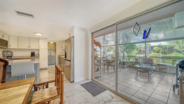 a view of a kitchen with dining room and furniture