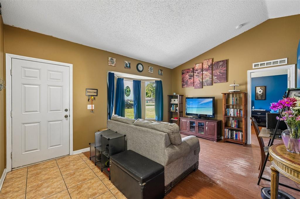 10303 Fordham Street Spring Hill, FL 34608 - Photo 3 of 25 a living room with furniture and a flat screen tv