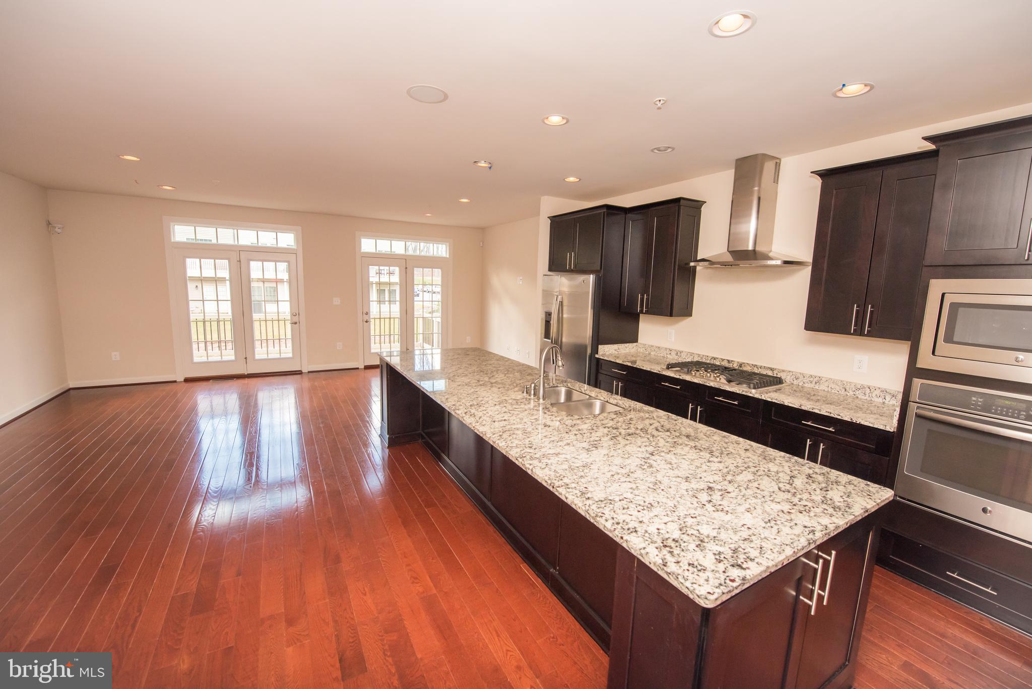 7444 Burnside Way Hanover, MD 21076 - Photo 5 of 46 a kitchen with large counter space and wooden floor