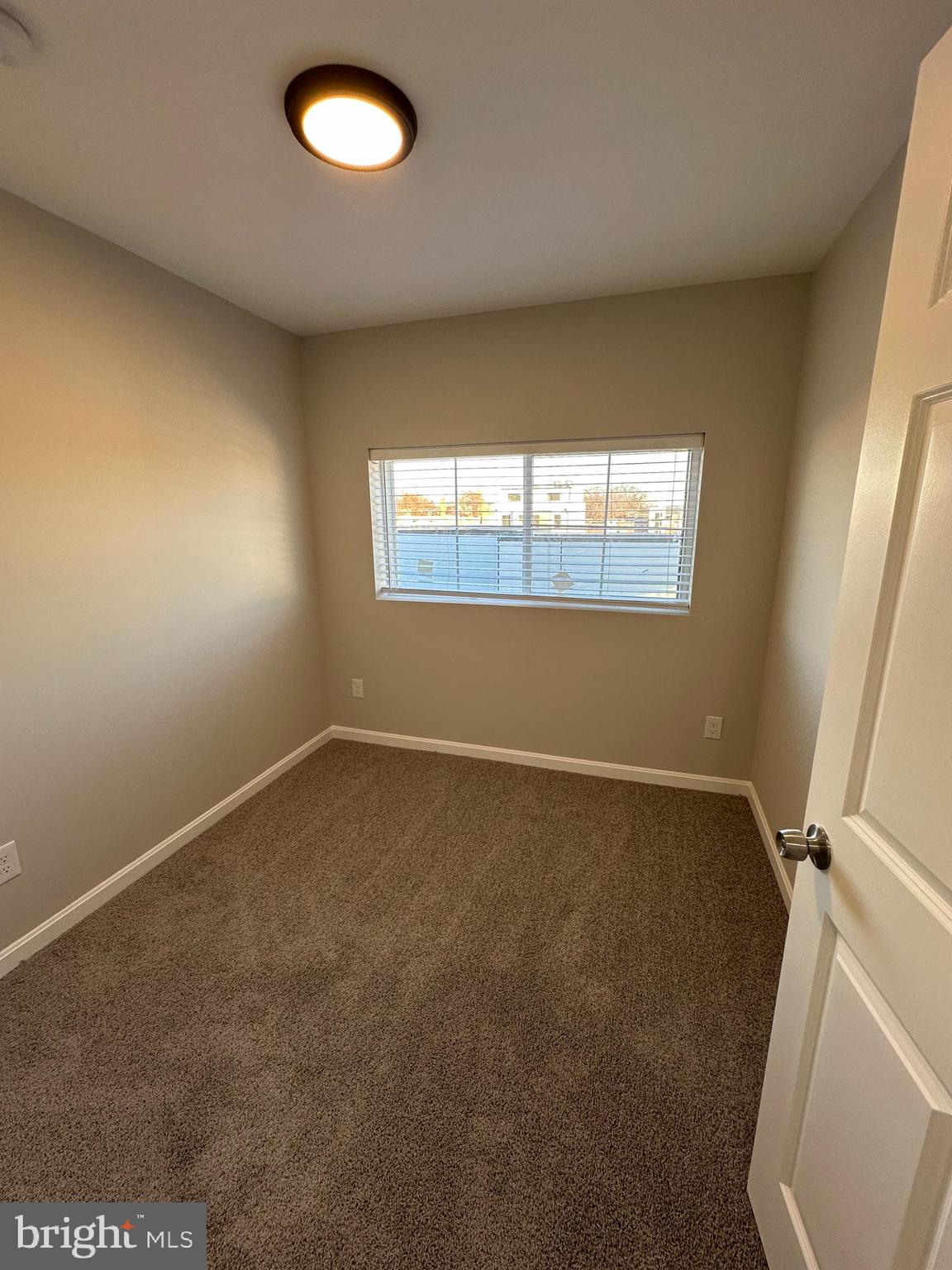 1812 H Place Northeast, Unit 409 Washington, DC 20002 - Photo 11 of 16 an empty room with a window