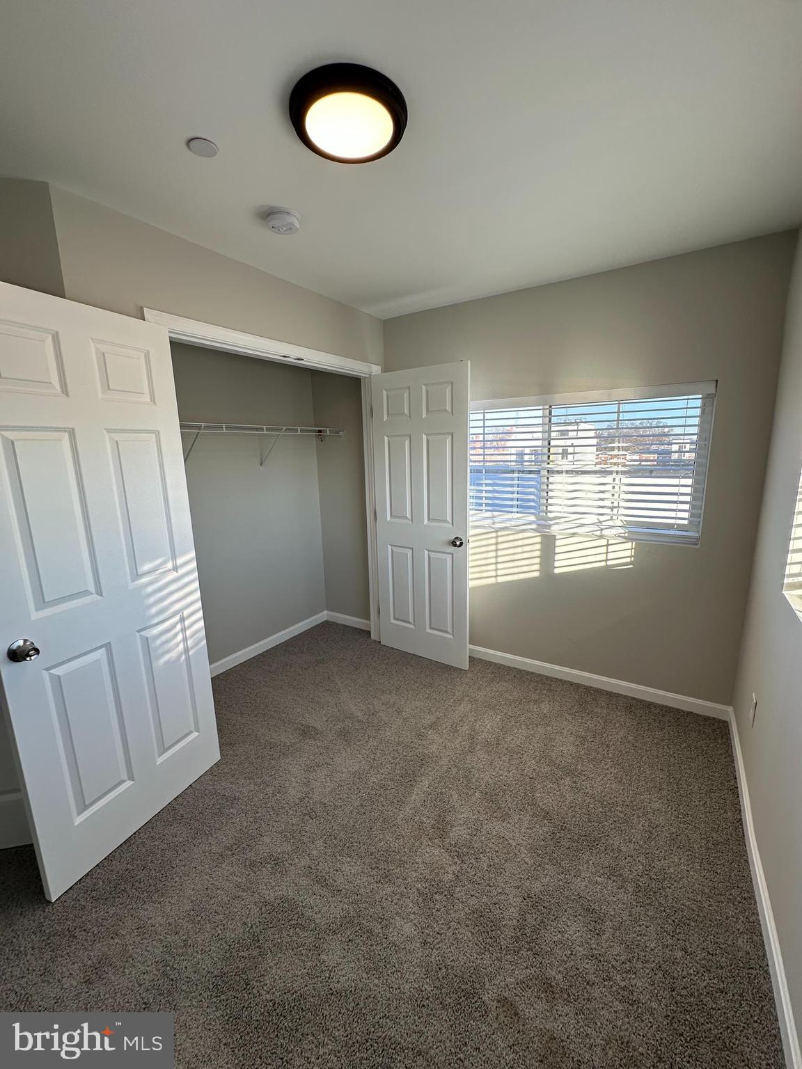 1812 H Place Northeast, Unit 409 Washington, DC 20002 - Photo 14 of 16 an empty room with windows