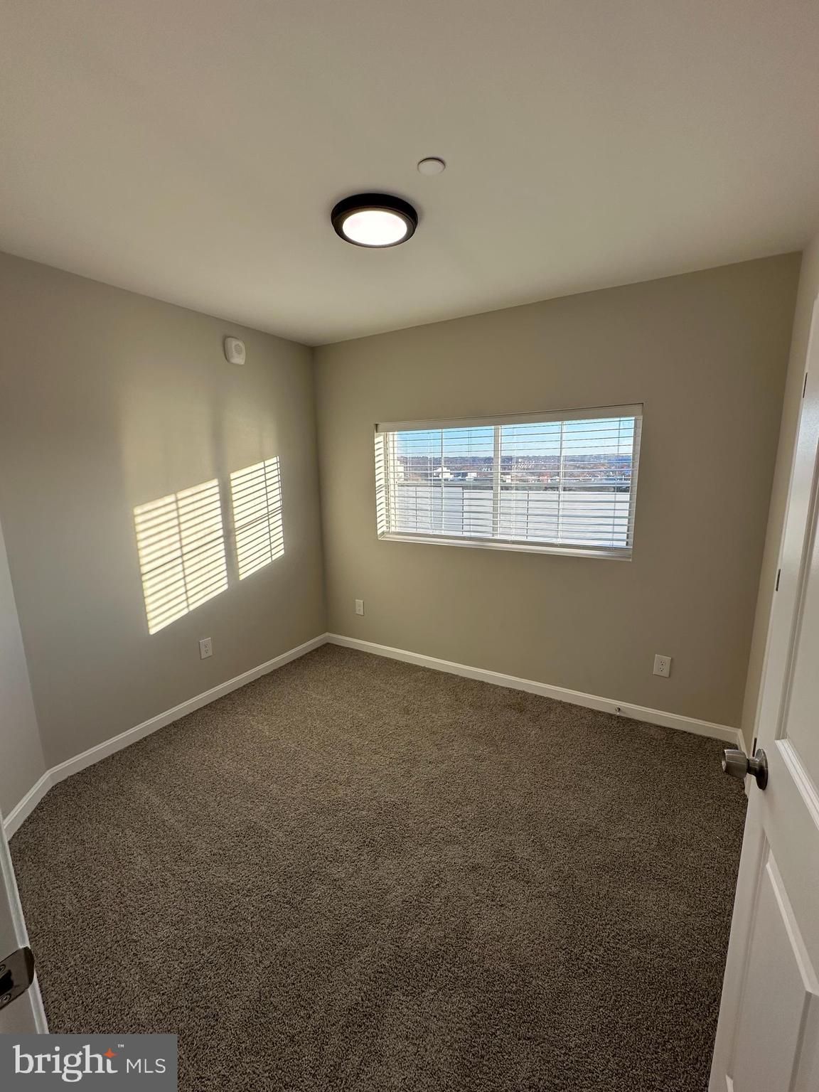 1812 H Place Northeast, Unit 409 Washington, DC 20002 - Photo 15 of 16 an empty room with windows