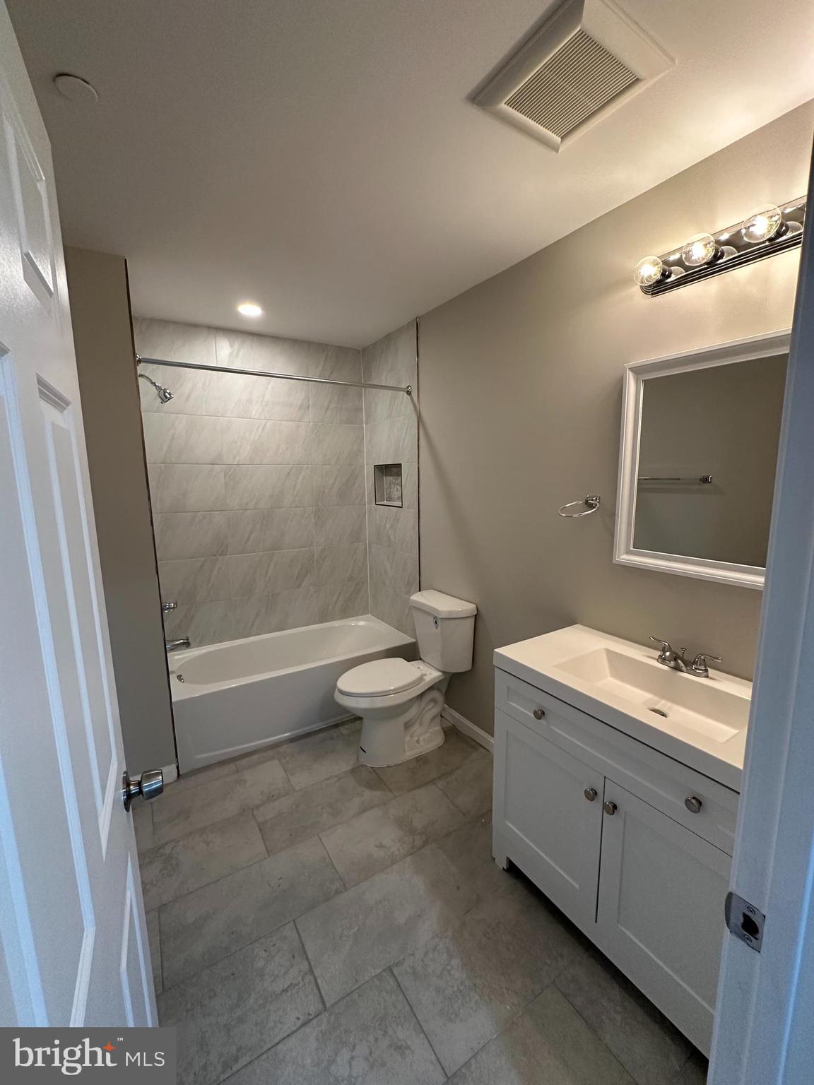 1812 H Place Northeast, Unit 409 Washington, DC 20002 - Photo 8 of 16 a bathroom with a double vanity sink toilet and shower