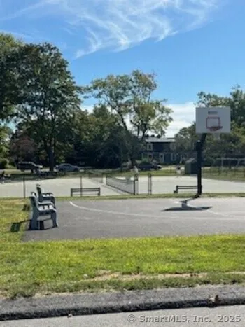 a view of a chairs and fire pit in the middle of a yard