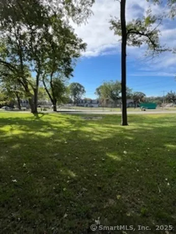 a view of a swimming pool and trees in the background