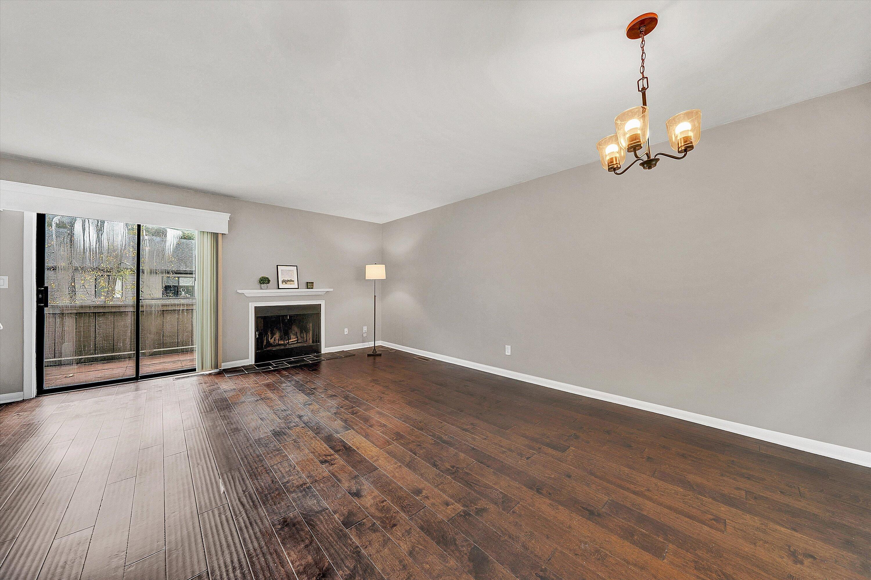 7313 Maple Court Southwest Roanoke, VA 24018 - Photo 11 of 38 a view of an empty room with wooden floor fireplace and a window