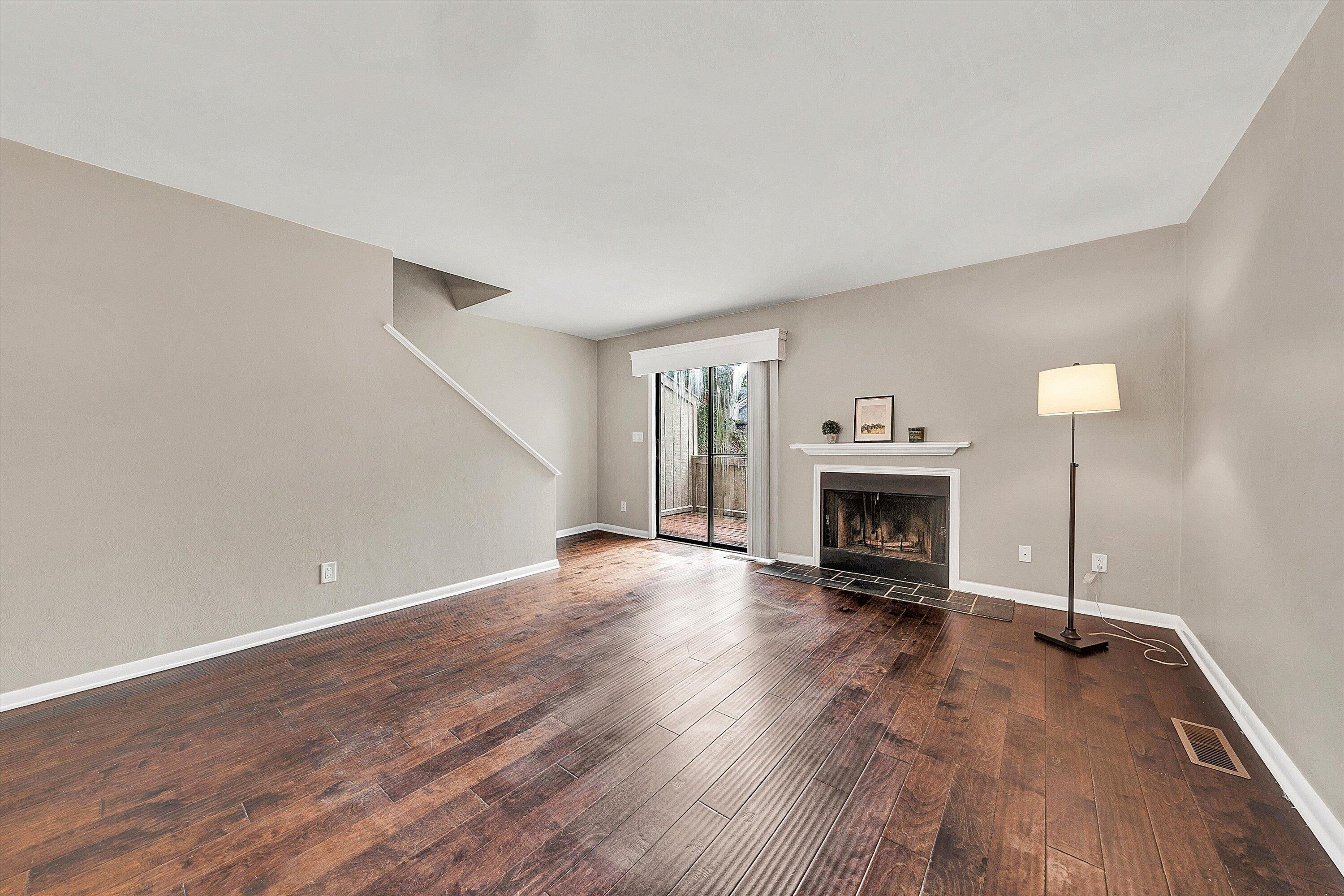 7313 Maple Court Southwest Roanoke, VA 24018 - Photo 13 of 38 a view of an empty room with wooden floor fireplace and a window