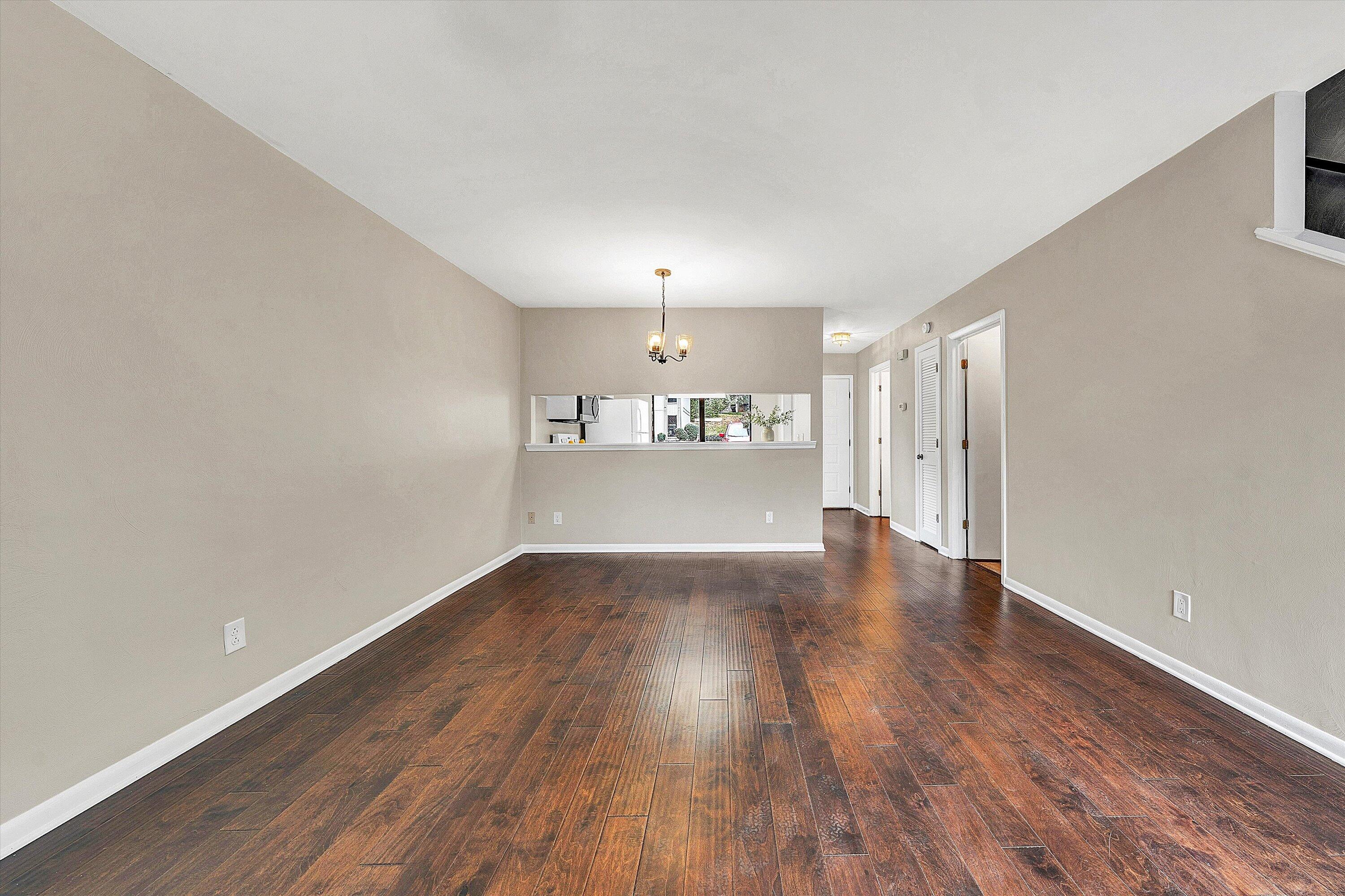 7313 Maple Court Southwest Roanoke, VA 24018 - Photo 14 of 38 wooden floor in an empty room with a window