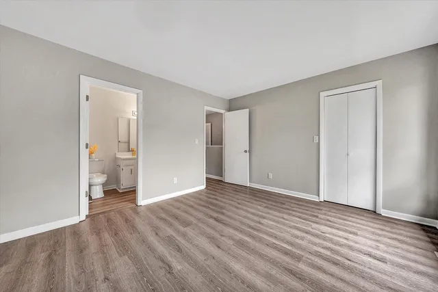 a view of an empty room and wooden floor