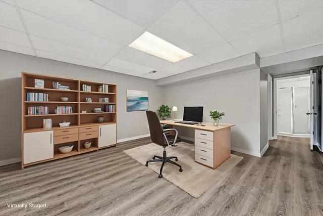 a view of a workspace with furniture and wooden floor