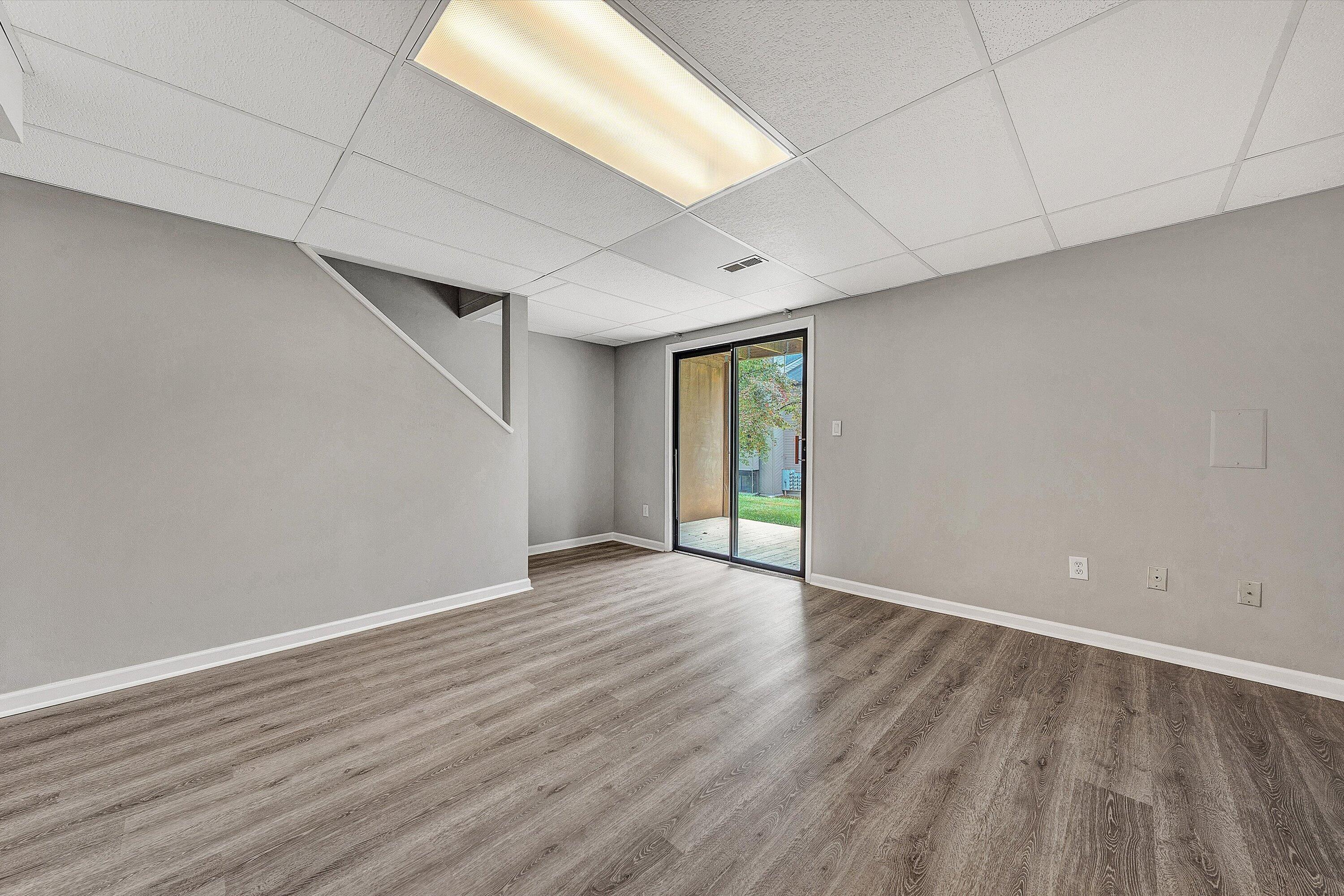 7313 Maple Court Southwest Roanoke, VA 24018 - Photo 27 of 38 a view of an empty room with window and wooden floor