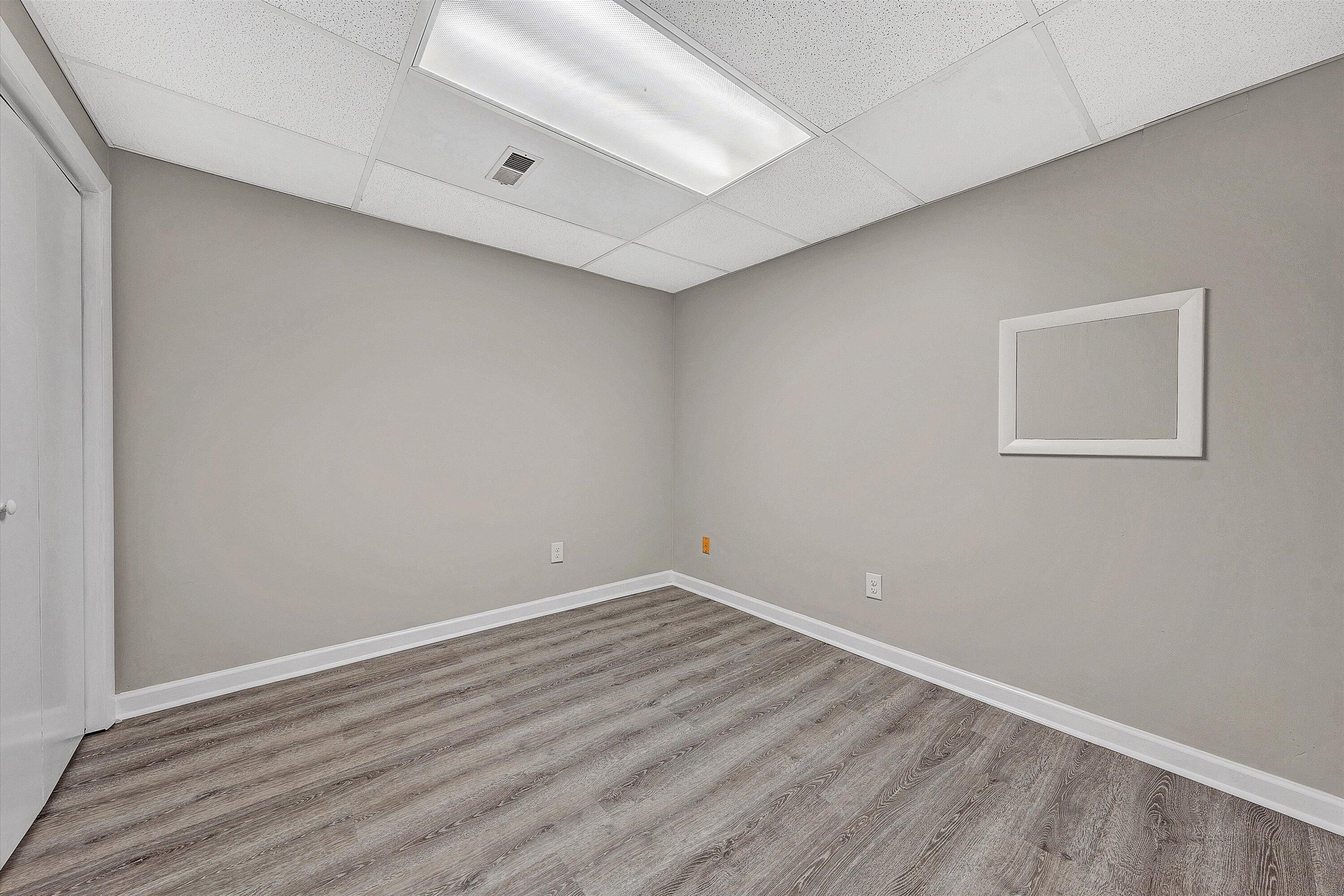 7313 Maple Court Southwest Roanoke, VA 24018 - Photo 28 of 38 an empty room with wooden floor and windows